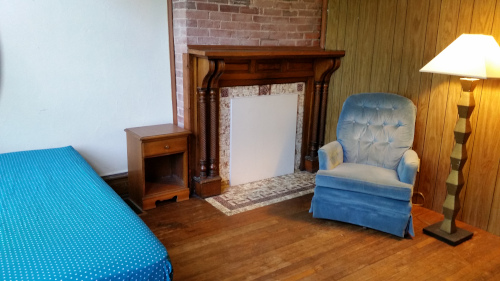 Front Bedroom with hardwood floors and decorative fireplace